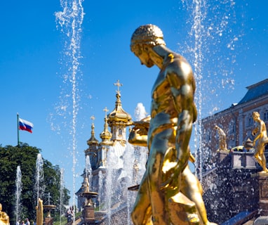 gold statue of man with flags on top