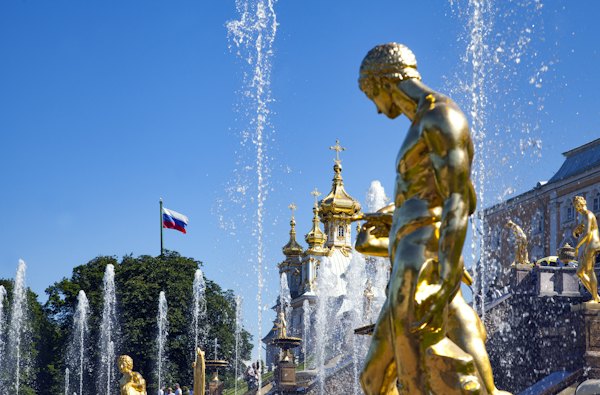Gold statue of man with flags on top