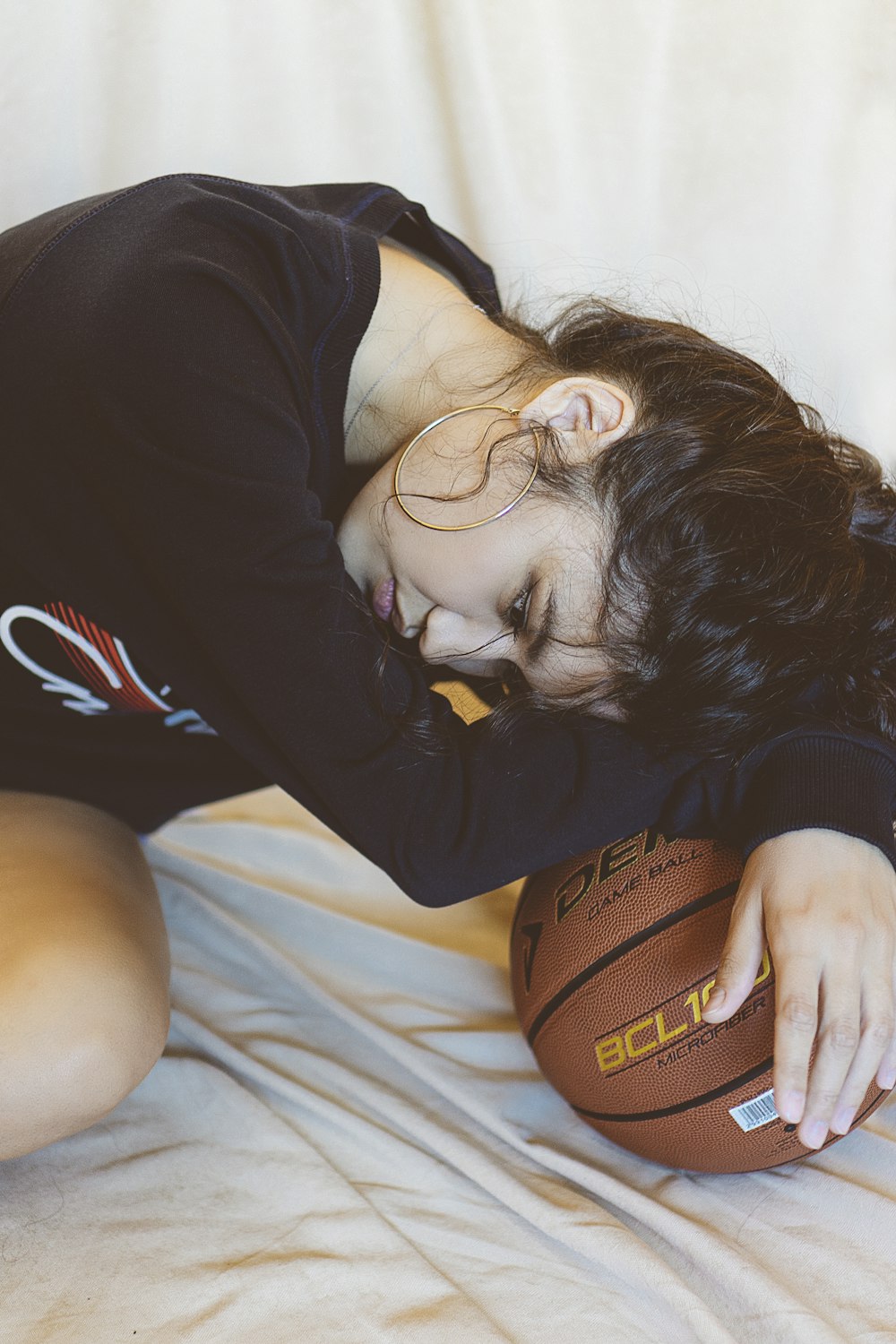 woman in black long sleeve shirt lying on bed