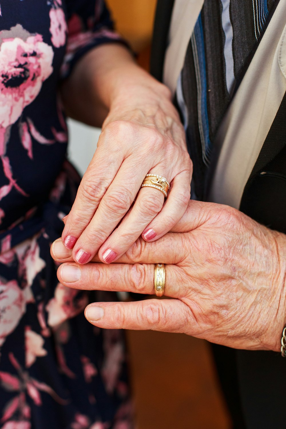 person wearing gold ring and gold ring