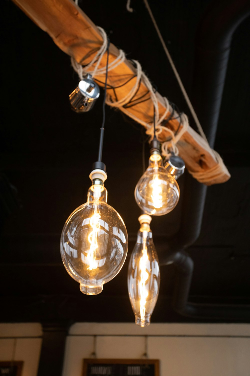 three clear glass pendant lamps