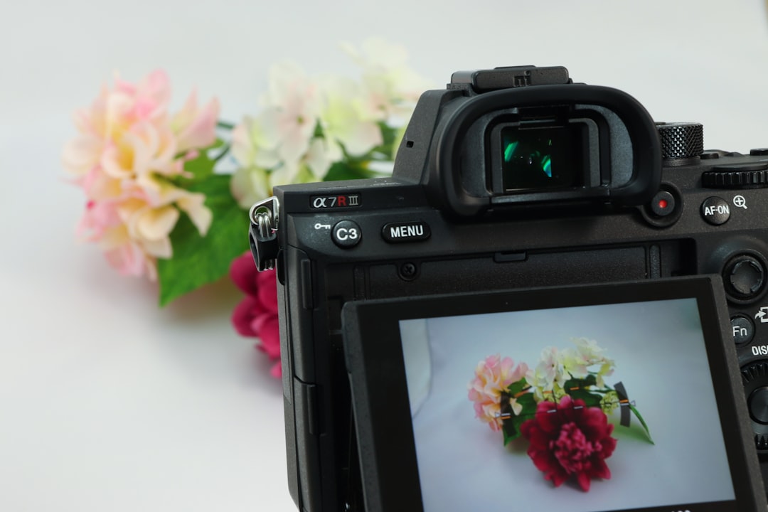 black canon dslr camera on white table