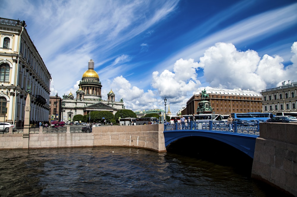 people walking on bridge over river during daytime