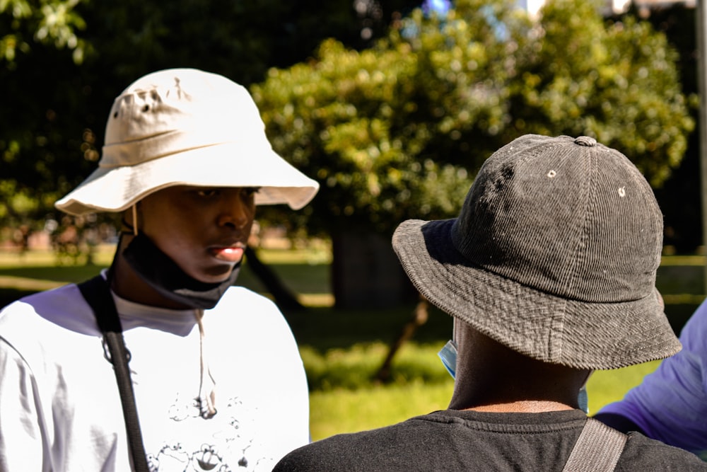 woman in white hat and gray shirt