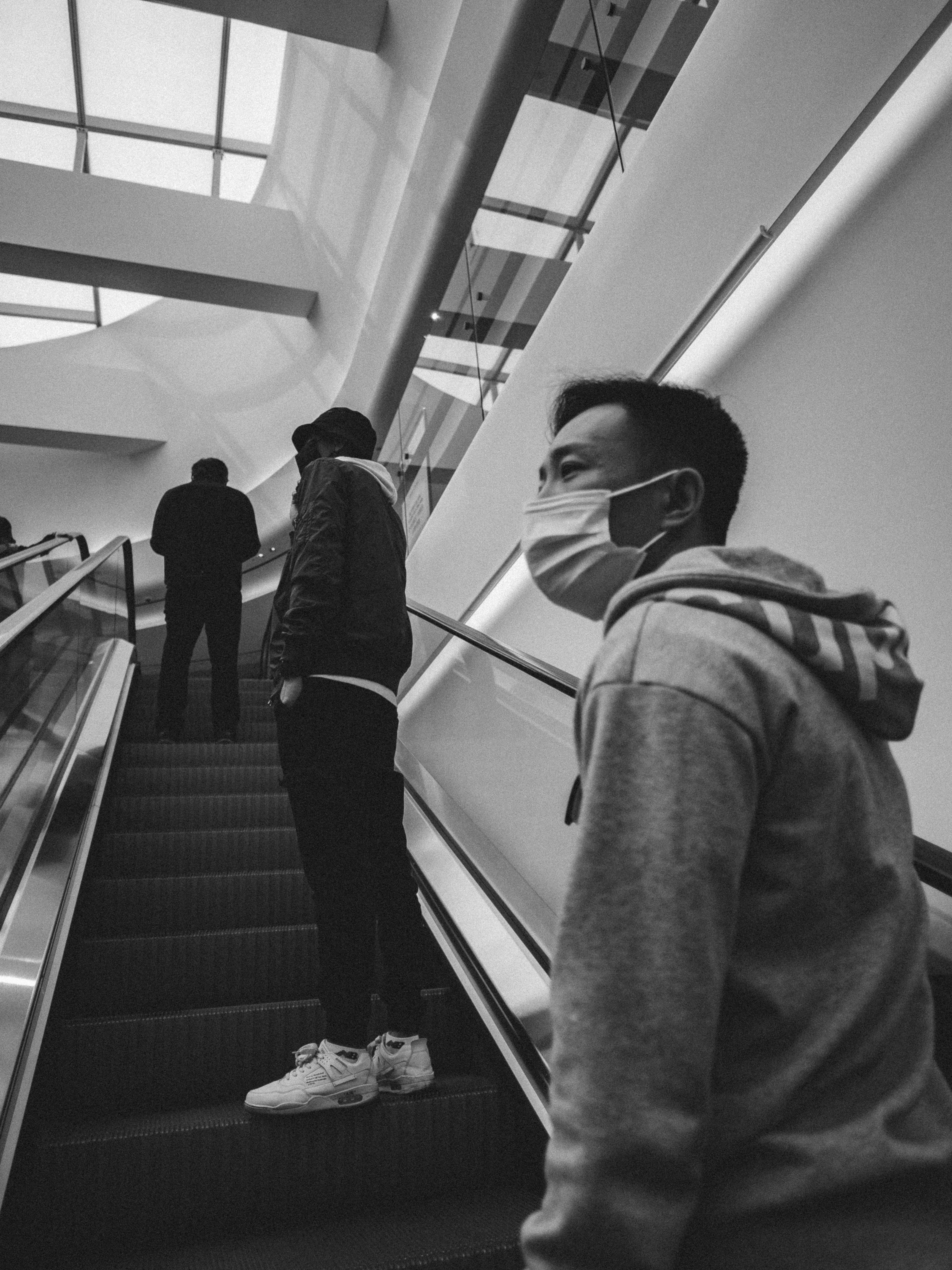 man in hoodie walking down the stairs