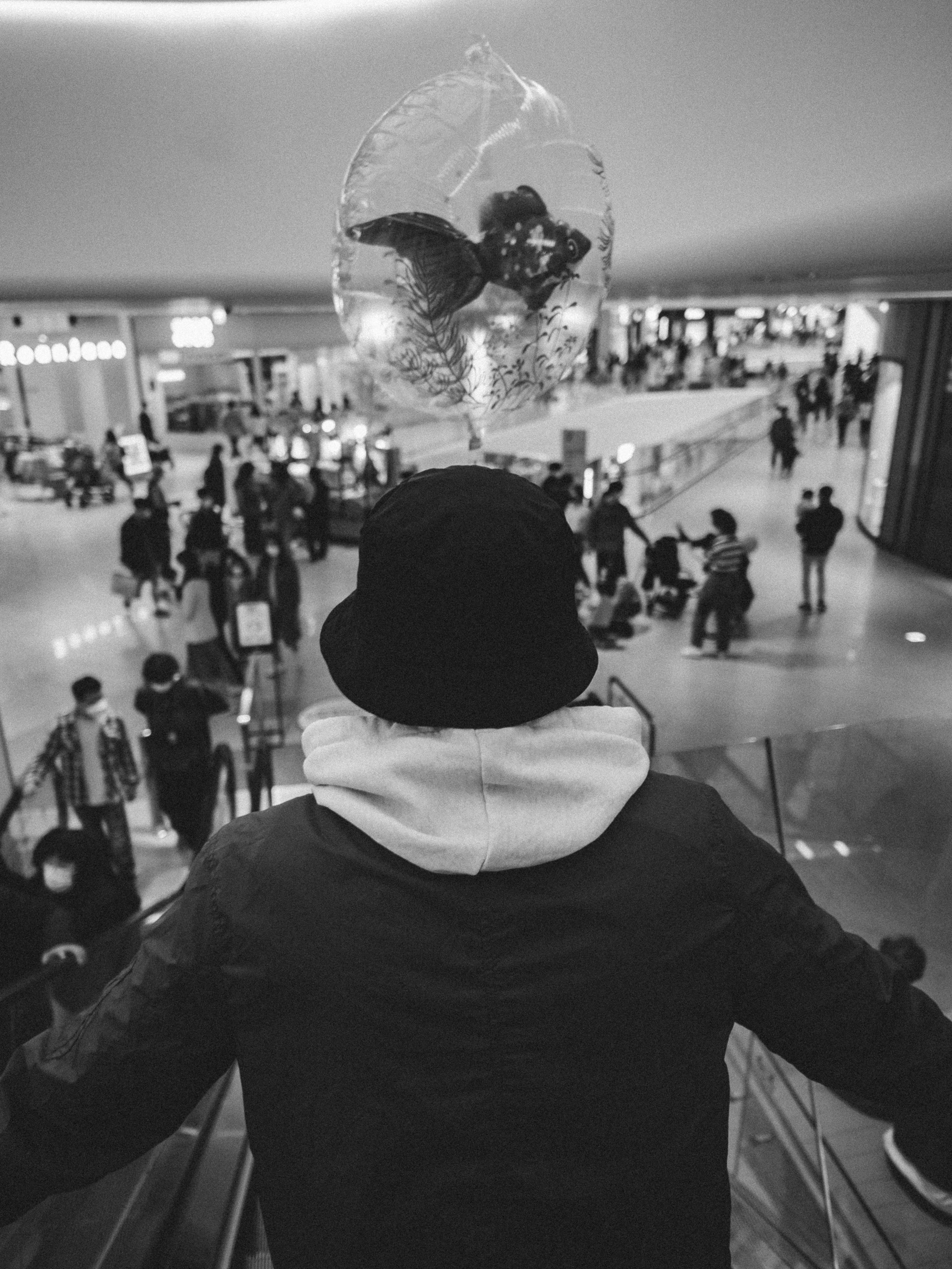 a person standing on an escalator in a building