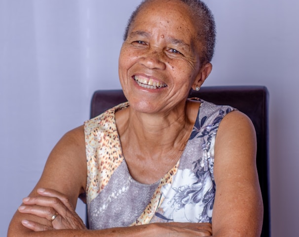 woman in white and gray tank top sitting on black chair