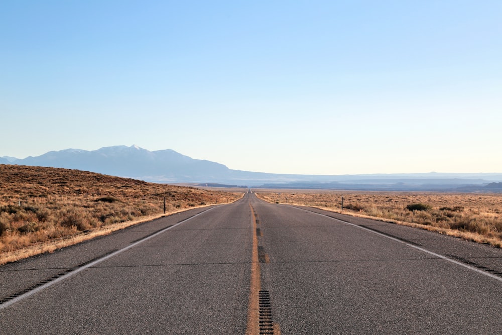 black asphalt road under blue sky during daytime