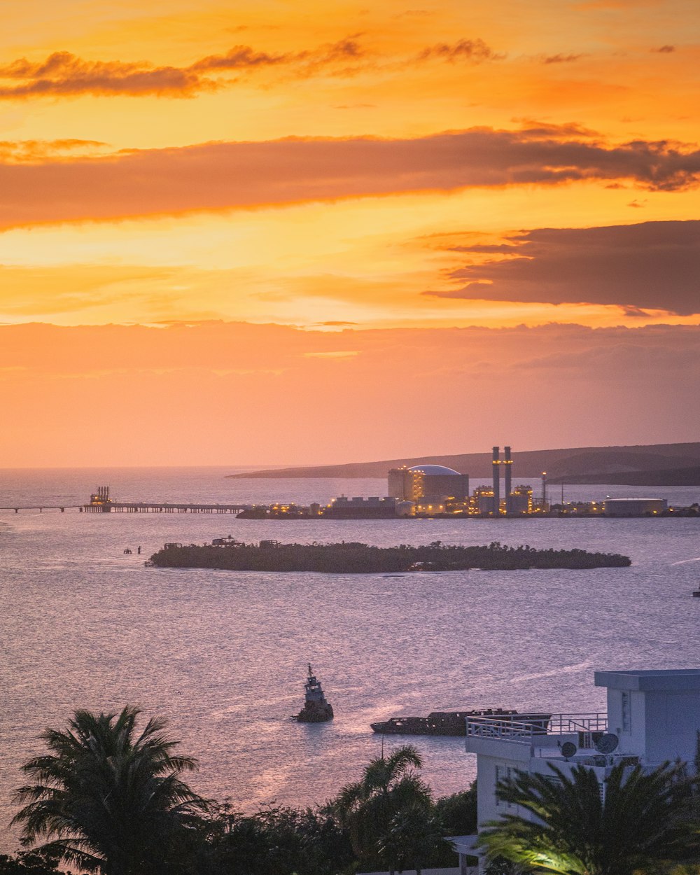 body of water near city buildings during sunset