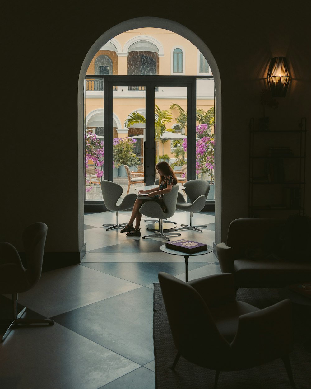 woman in white shirt sitting on chair