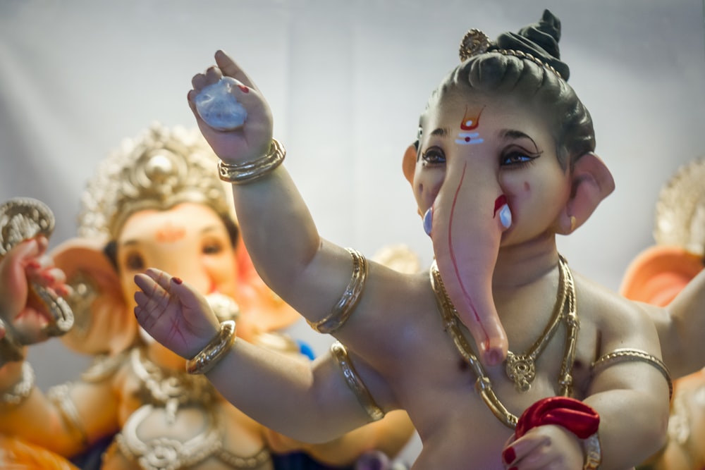 a statue of an elephant with a ring around its mouth