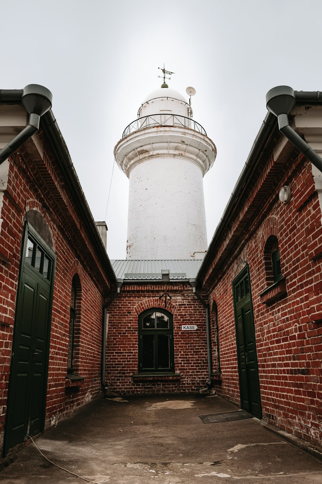 brown brick building with white light tower