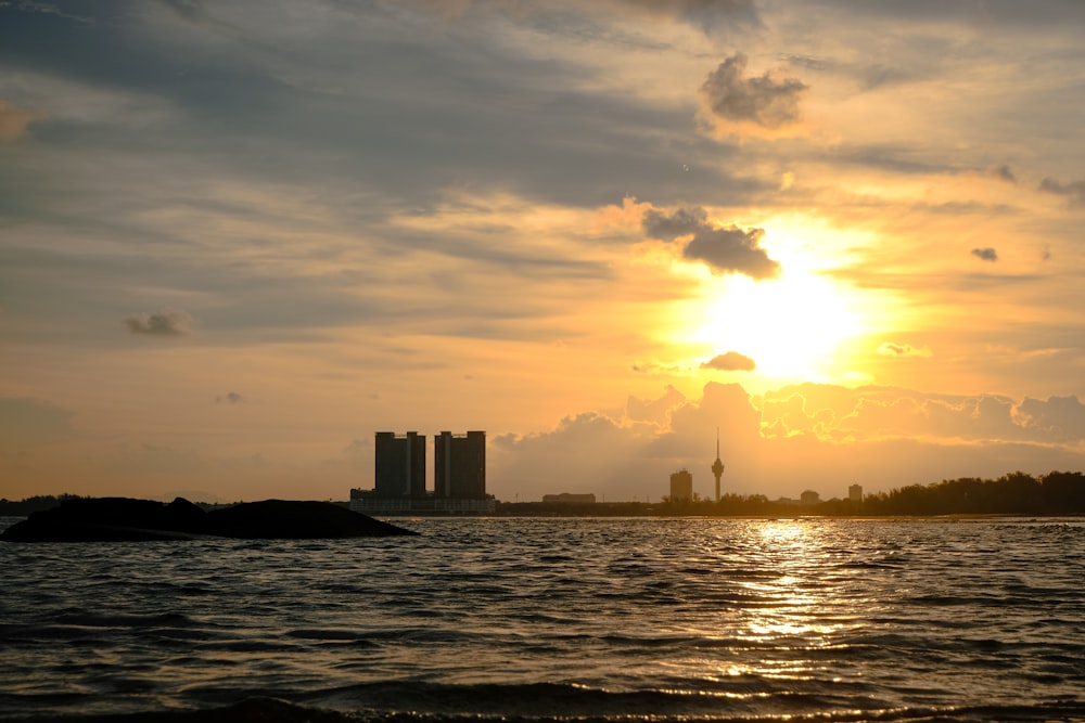 silhouette of city buildings during sunset