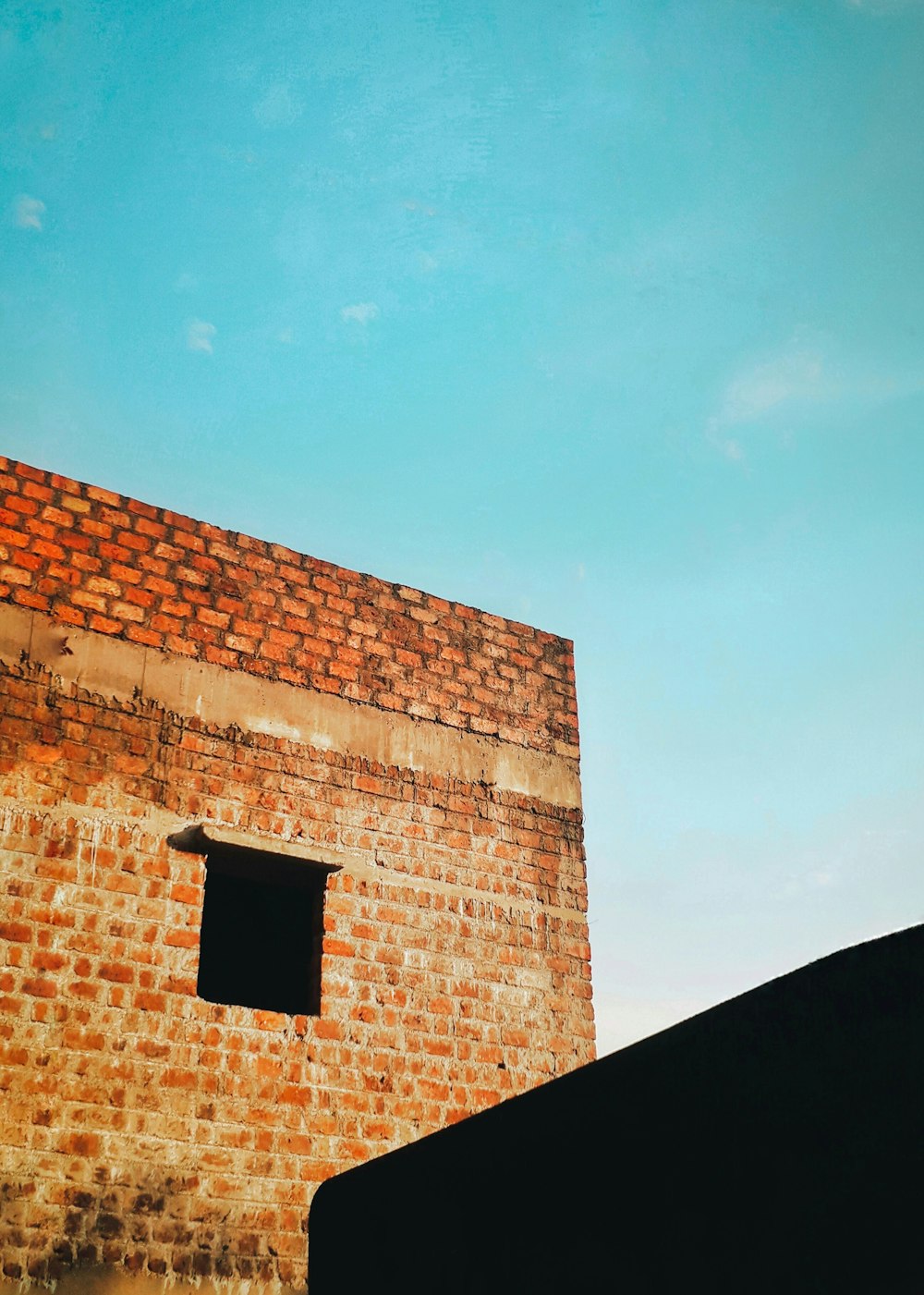 brown brick building under blue sky during daytime