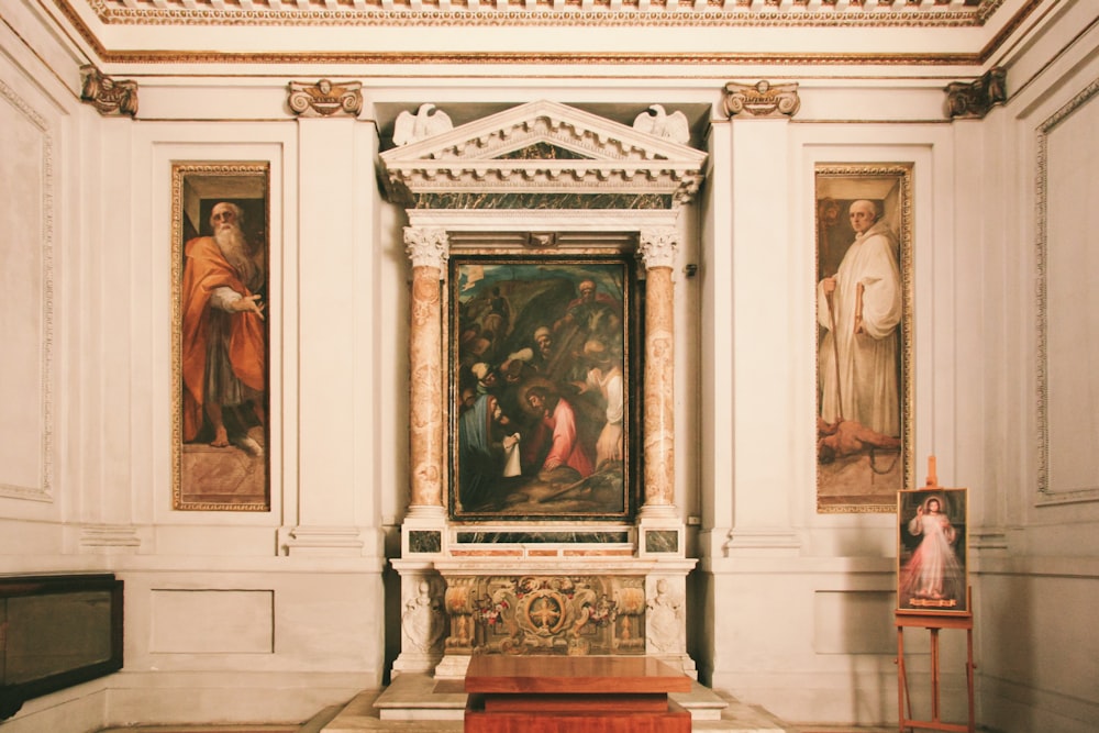 woman in brown dress standing in front of the painting