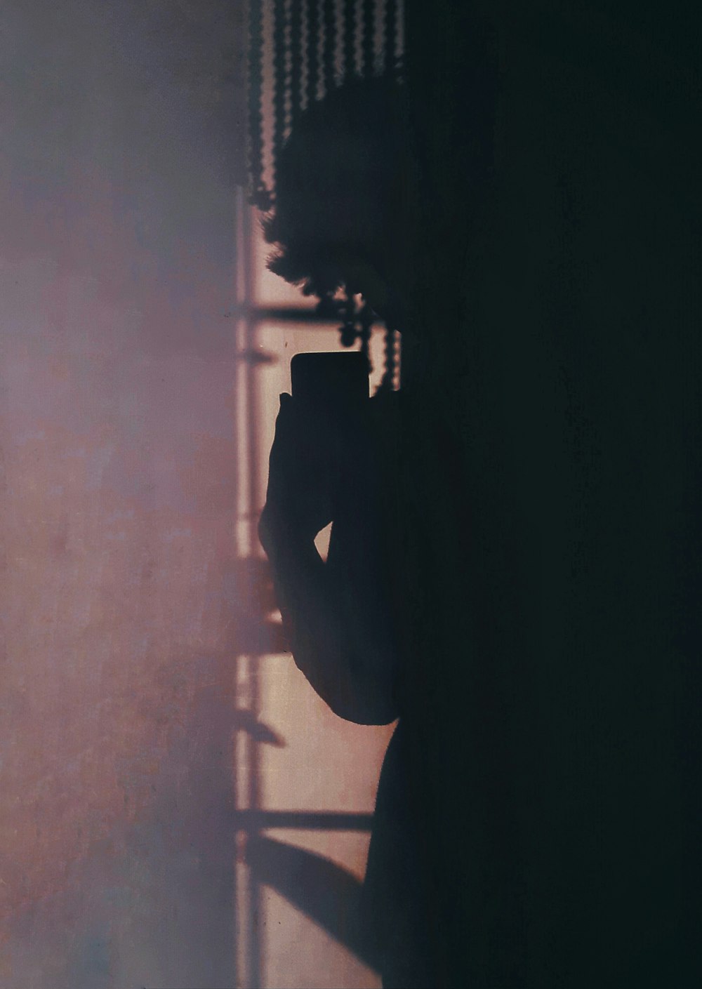 silhouette of person standing on gray concrete floor