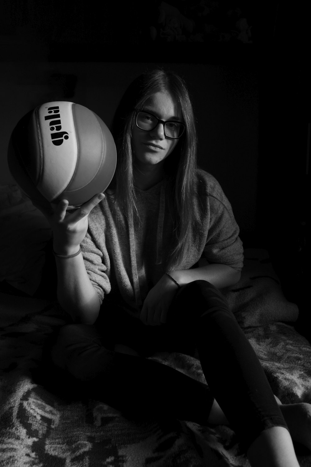 woman in black long sleeve shirt holding white and black ball