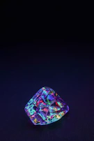 Close-up of a fiery orange sapphire capturing the vibrant hues under natural light.