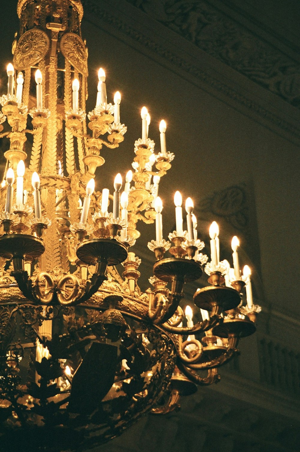 brass uplight chandelier turned on in room