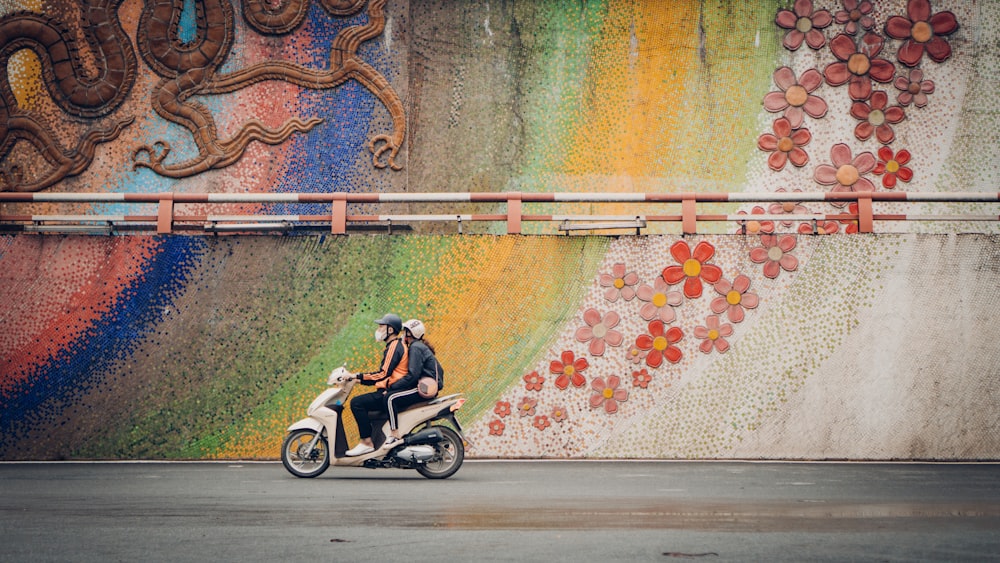 man riding motorcycle on road during daytime