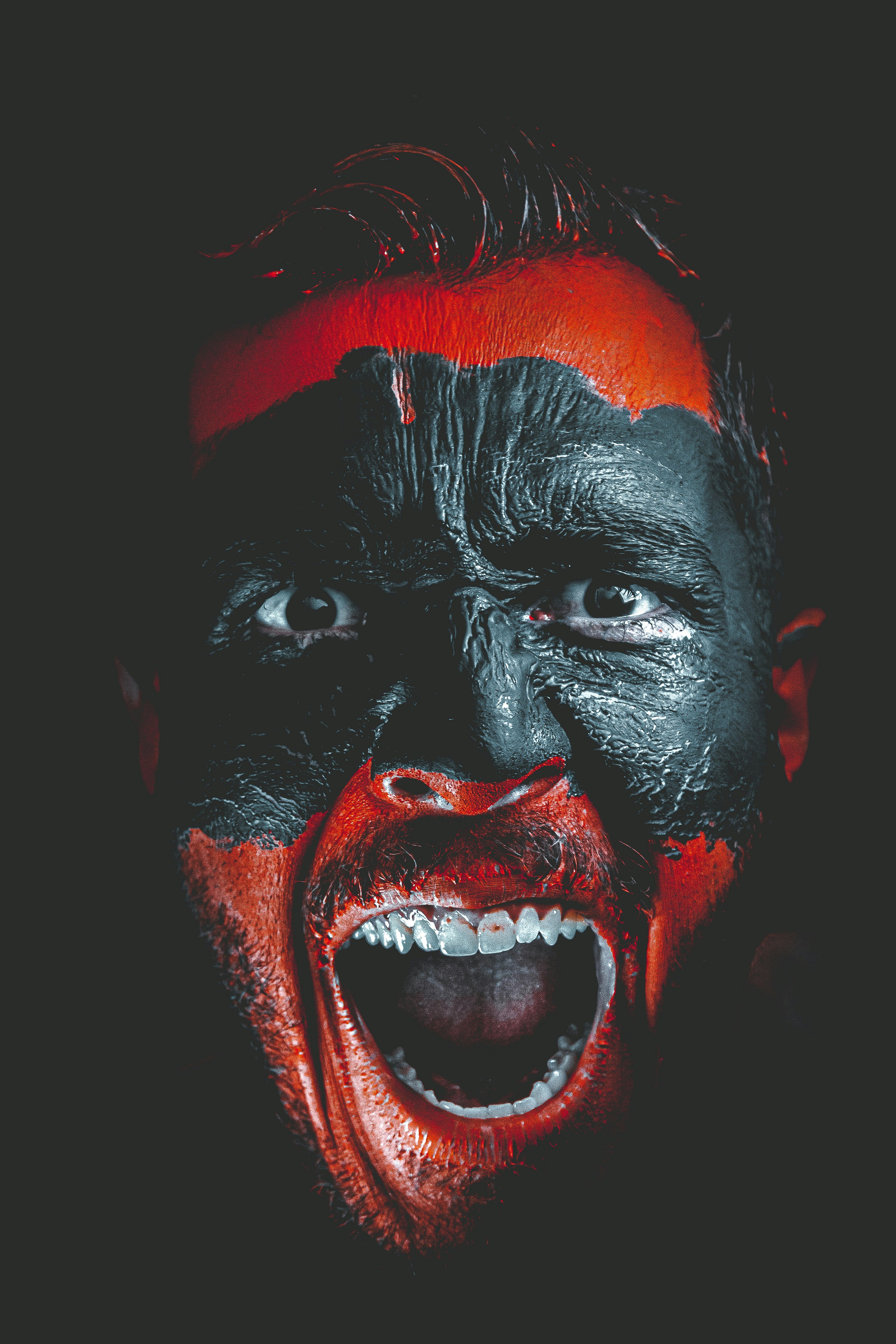 person with red and black face paint