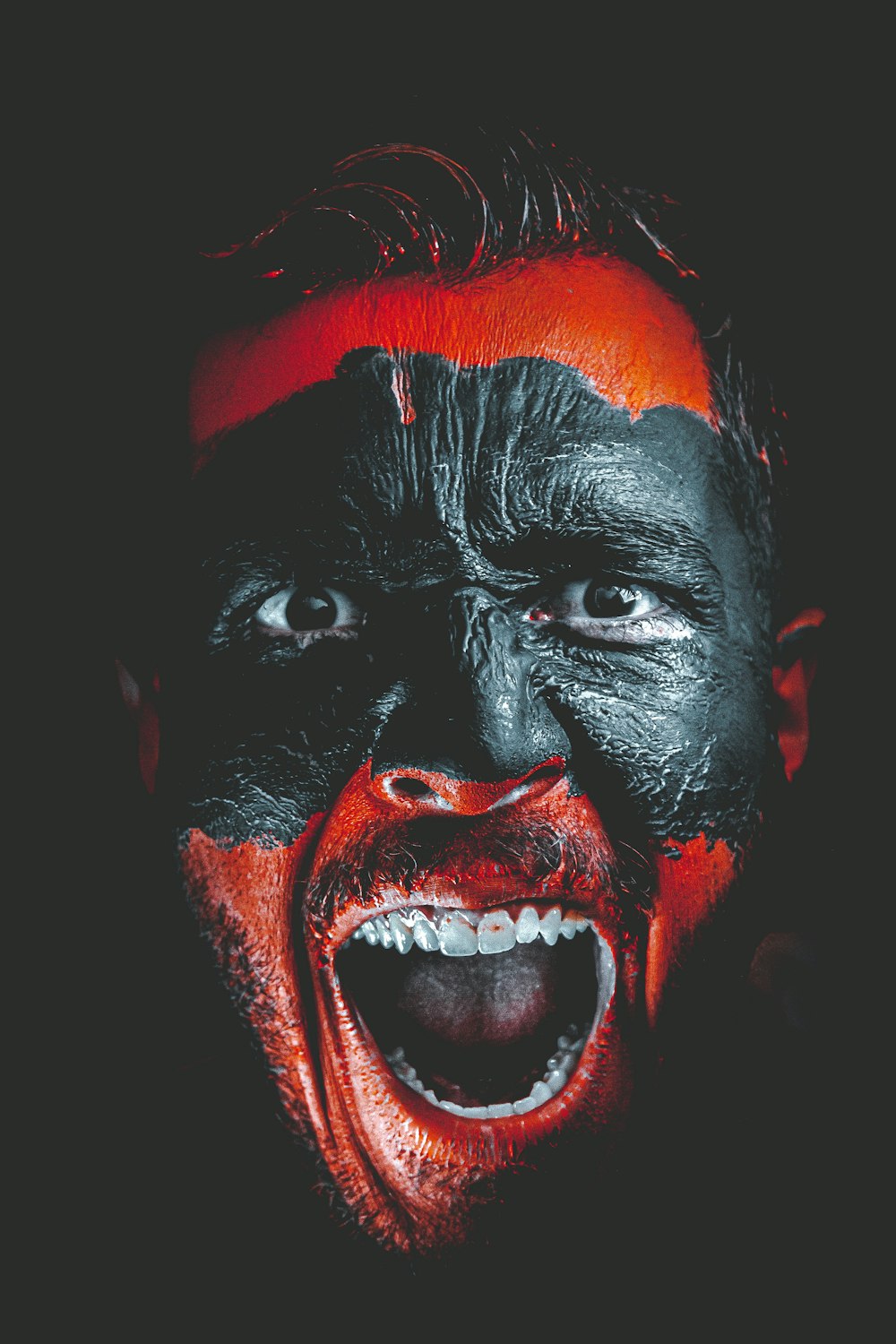 person with red and black face paint