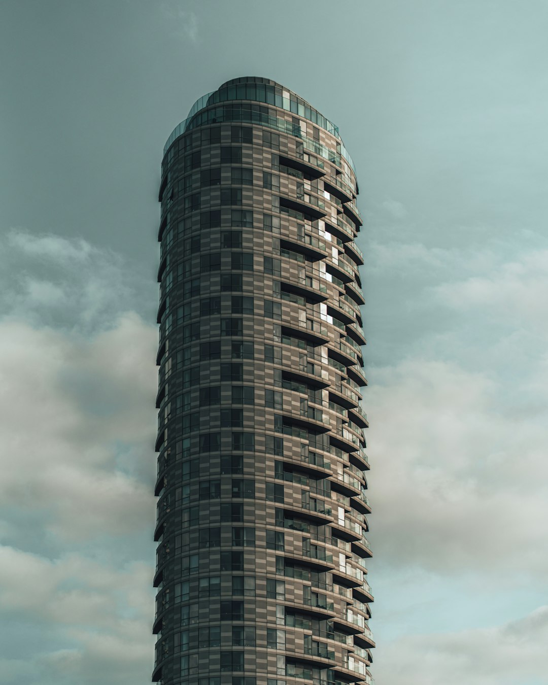 black and white concrete building under white clouds