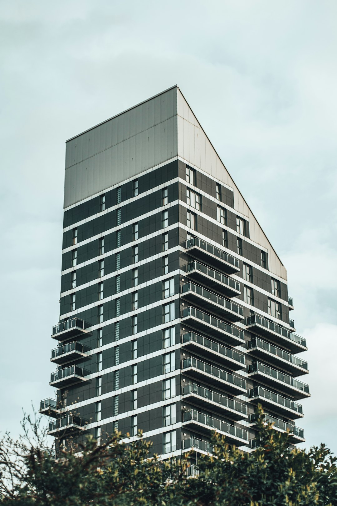 white and black concrete building under white clouds during daytime