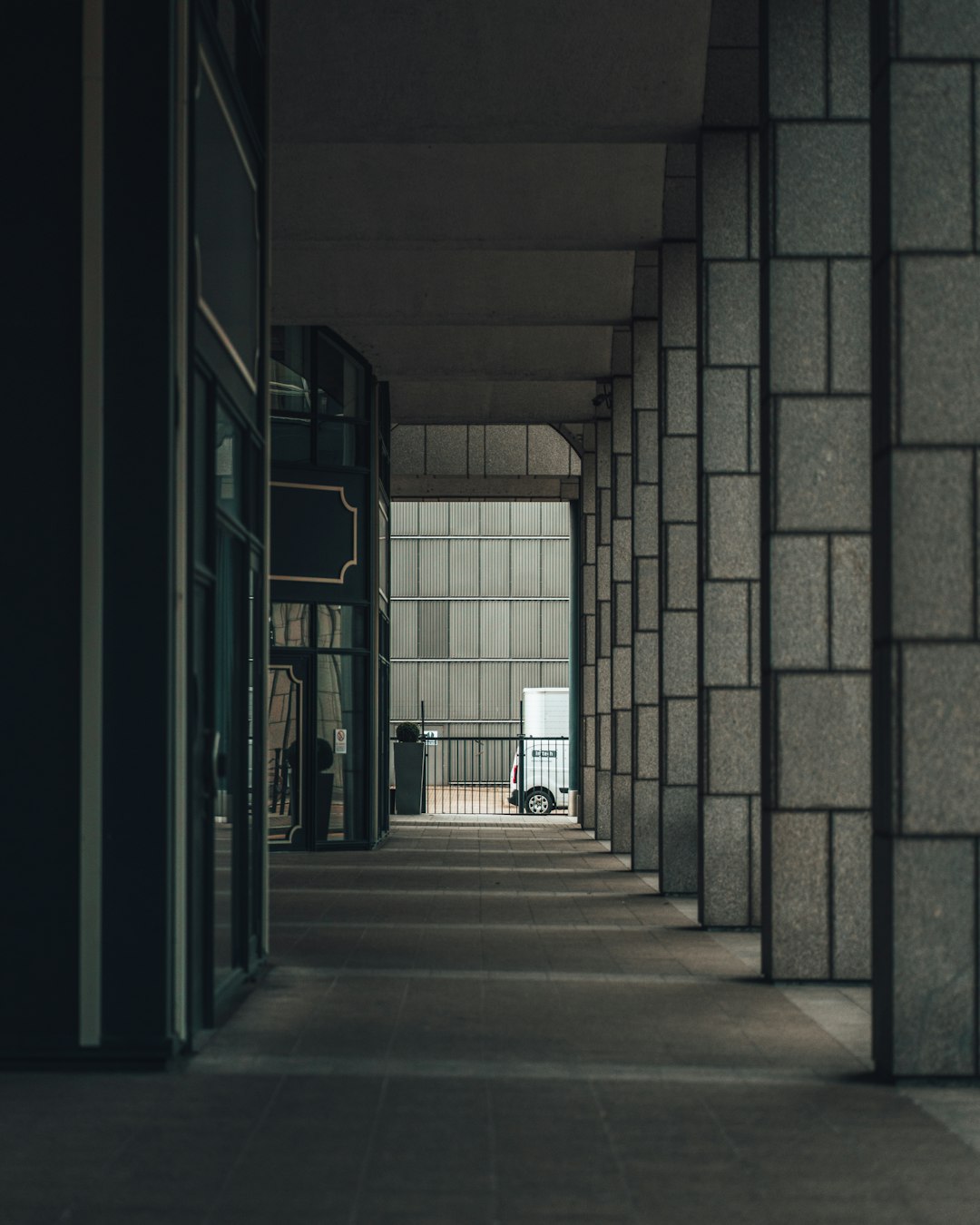 person in black jacket walking on hallway