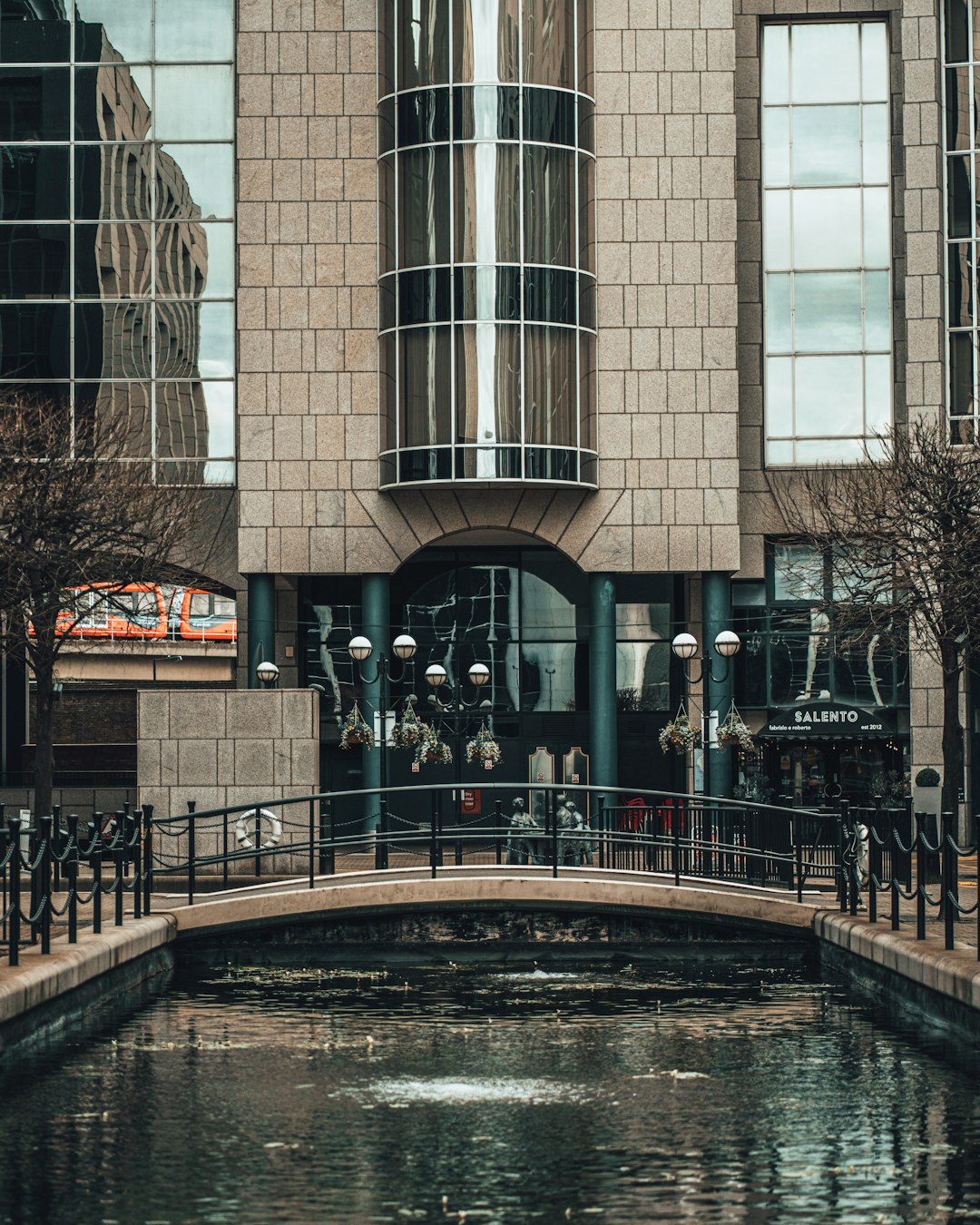 people walking on sidewalk near brown concrete building during daytime