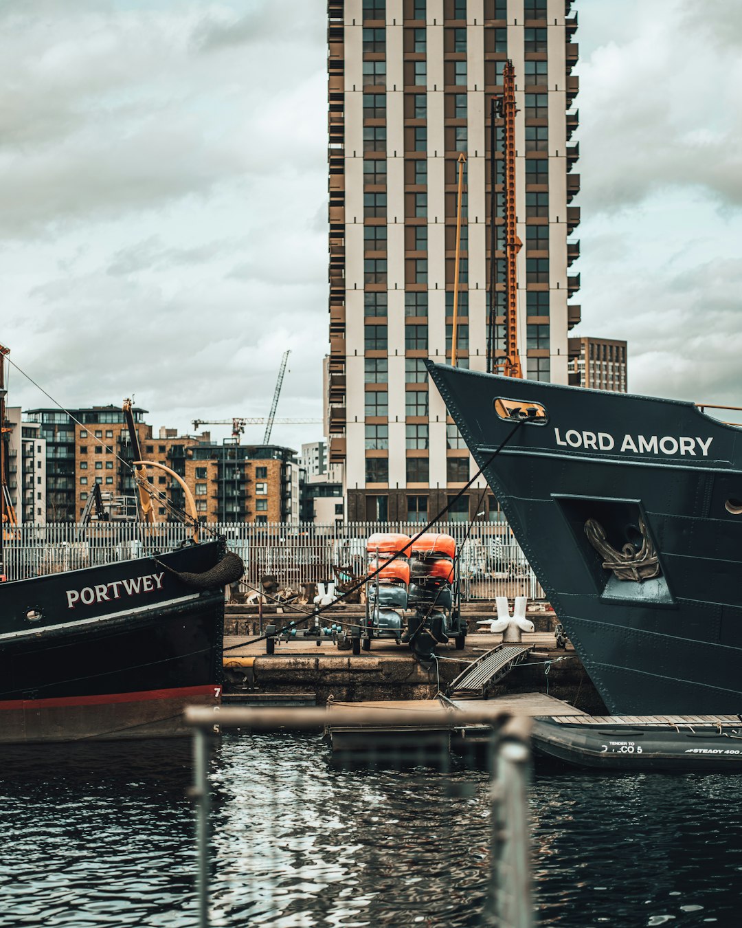 blue and white ship on water near city buildings during daytime