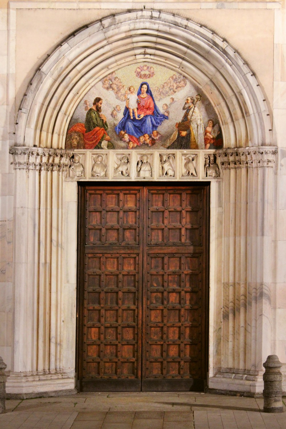 brown wooden door with religious painting