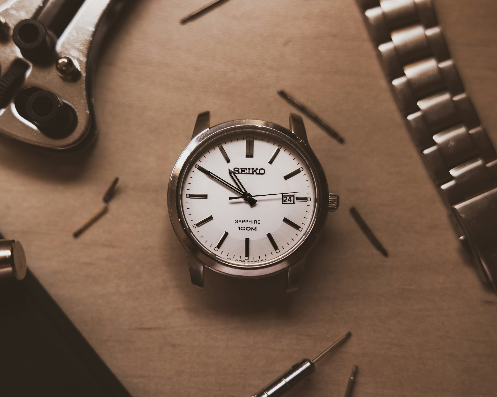 silver and white analog watch at 10 10
