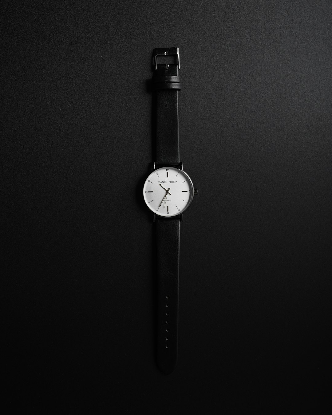 black leather strap silver round analog watch