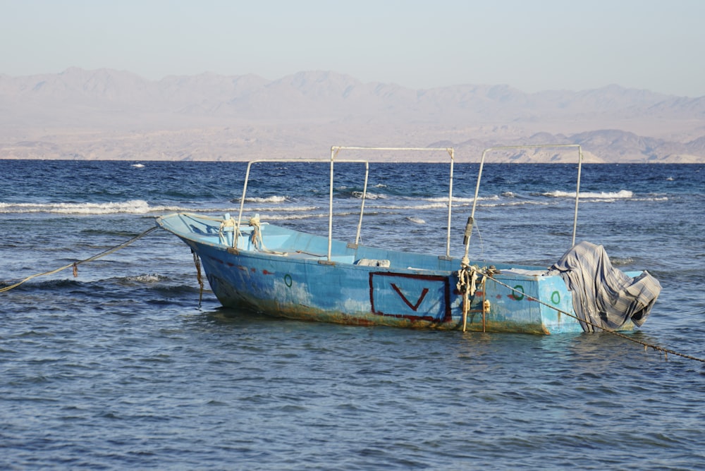 brown and white boat on sea during daytime