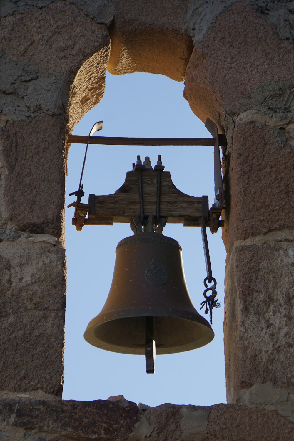 brown bell on brown concrete wall