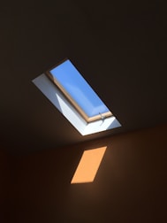 Roof window letting natural light into a bright attic room.