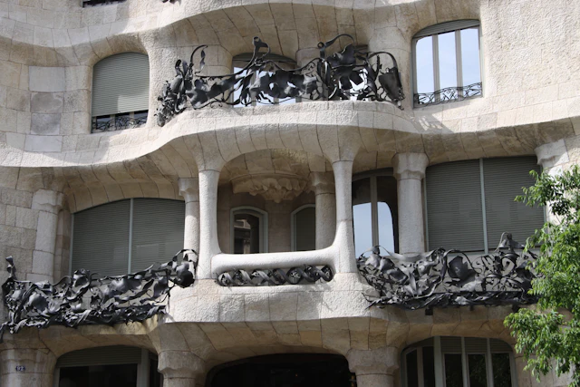 Close-up of La Pedrera's wavy stone facade and twisted wrought-iron balcony railings