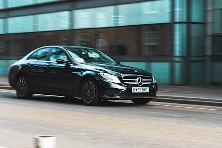 black mercedes benz coupe on road