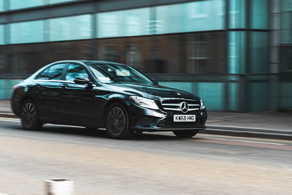 black mercedes benz coupe on road