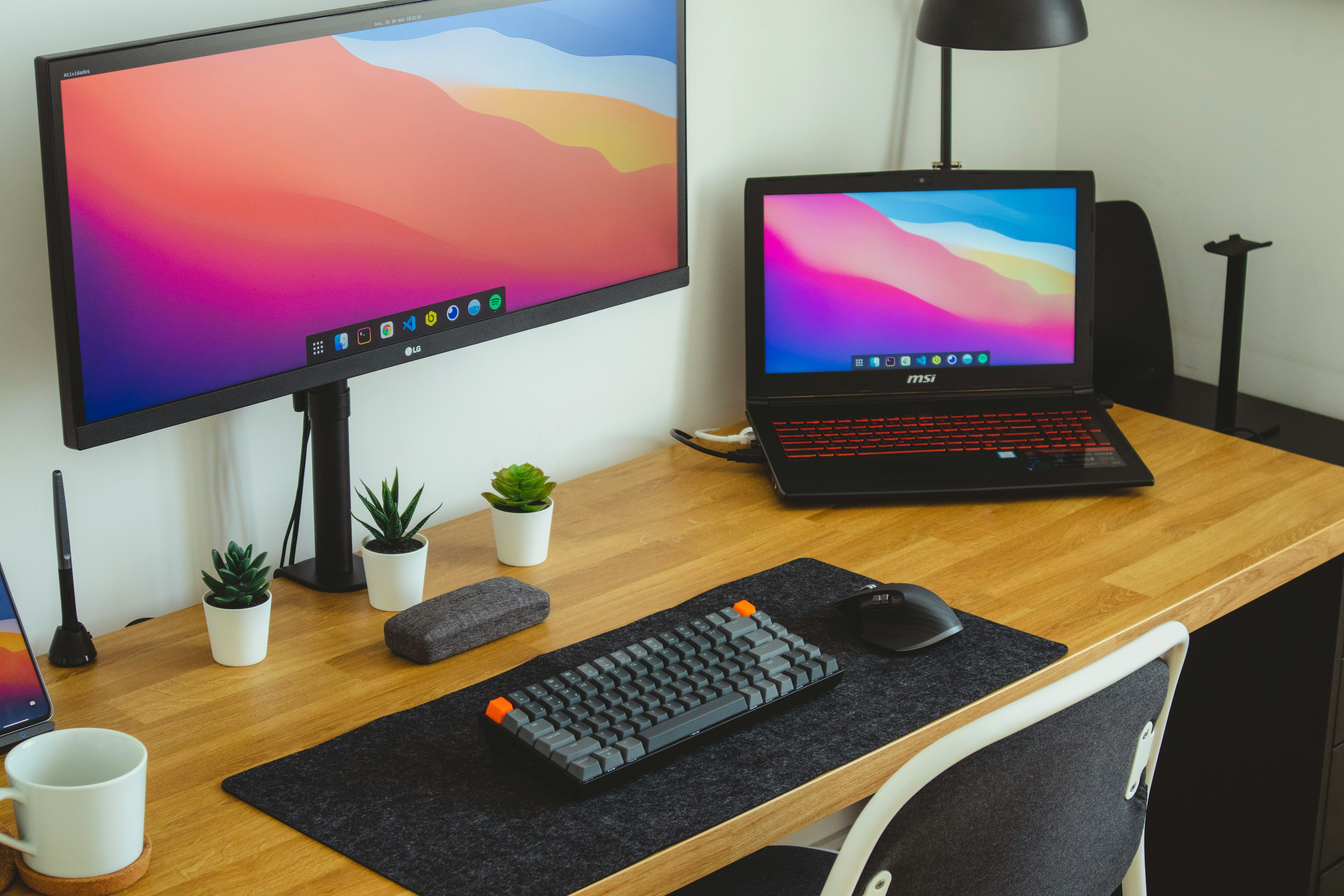 black flat screen computer monitor and black computer keyboard on brown wooden table