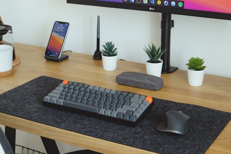 black computer keyboard on brown wooden table