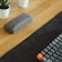 Close-up of a sleek black and gold neoprene desk mat with a serene zen design.