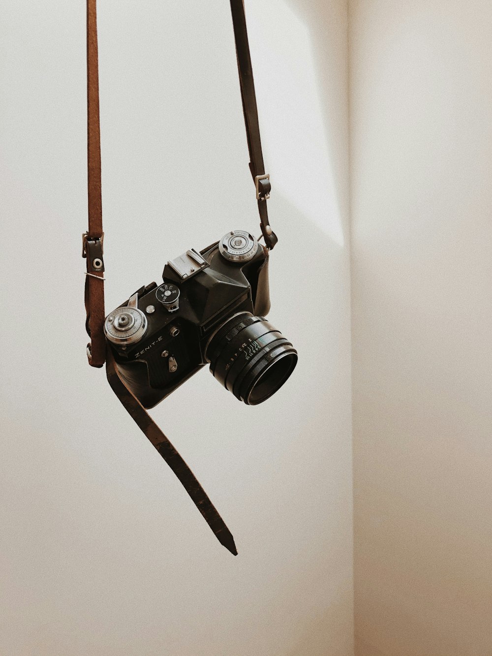 black dslr camera on white wall