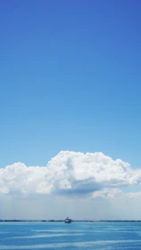 A serene beach cruise ship sailing under a clear blue sky, inviting relaxation.