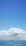 A serene ocean view with a cruise ship sailing under a clear blue sky.