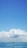 A serene ocean view with a cruise ship sailing under a clear blue sky.