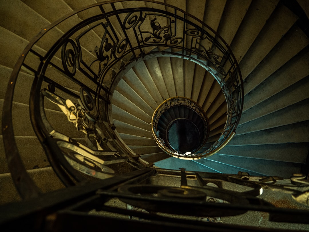 black spiral staircase with blue metal railings