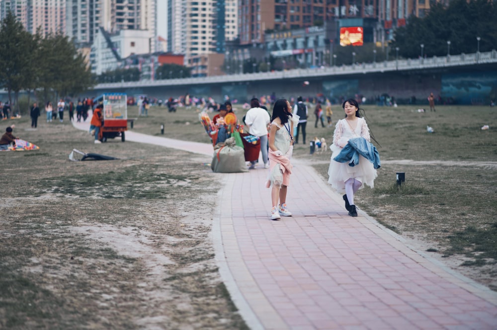 people walking on gray concrete pathway during daytime