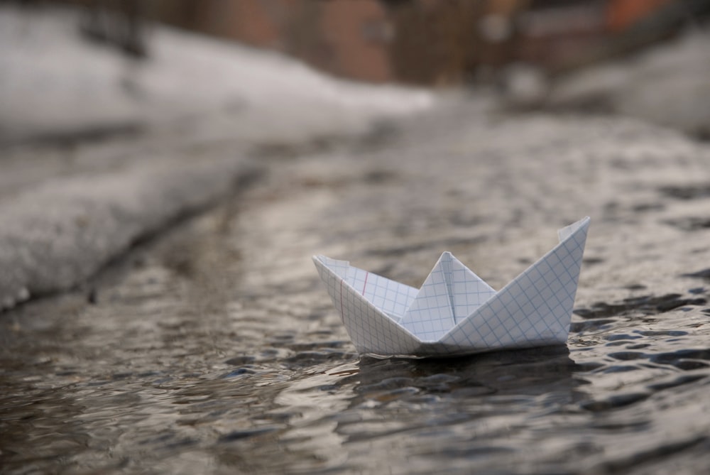 white paper boat on water